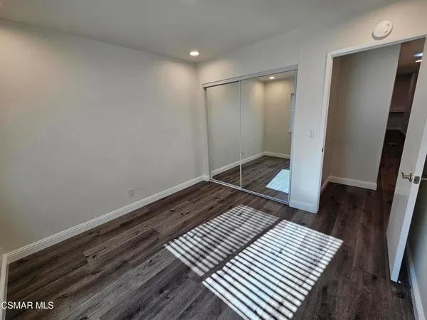 a bedroom with a bed and a mirror