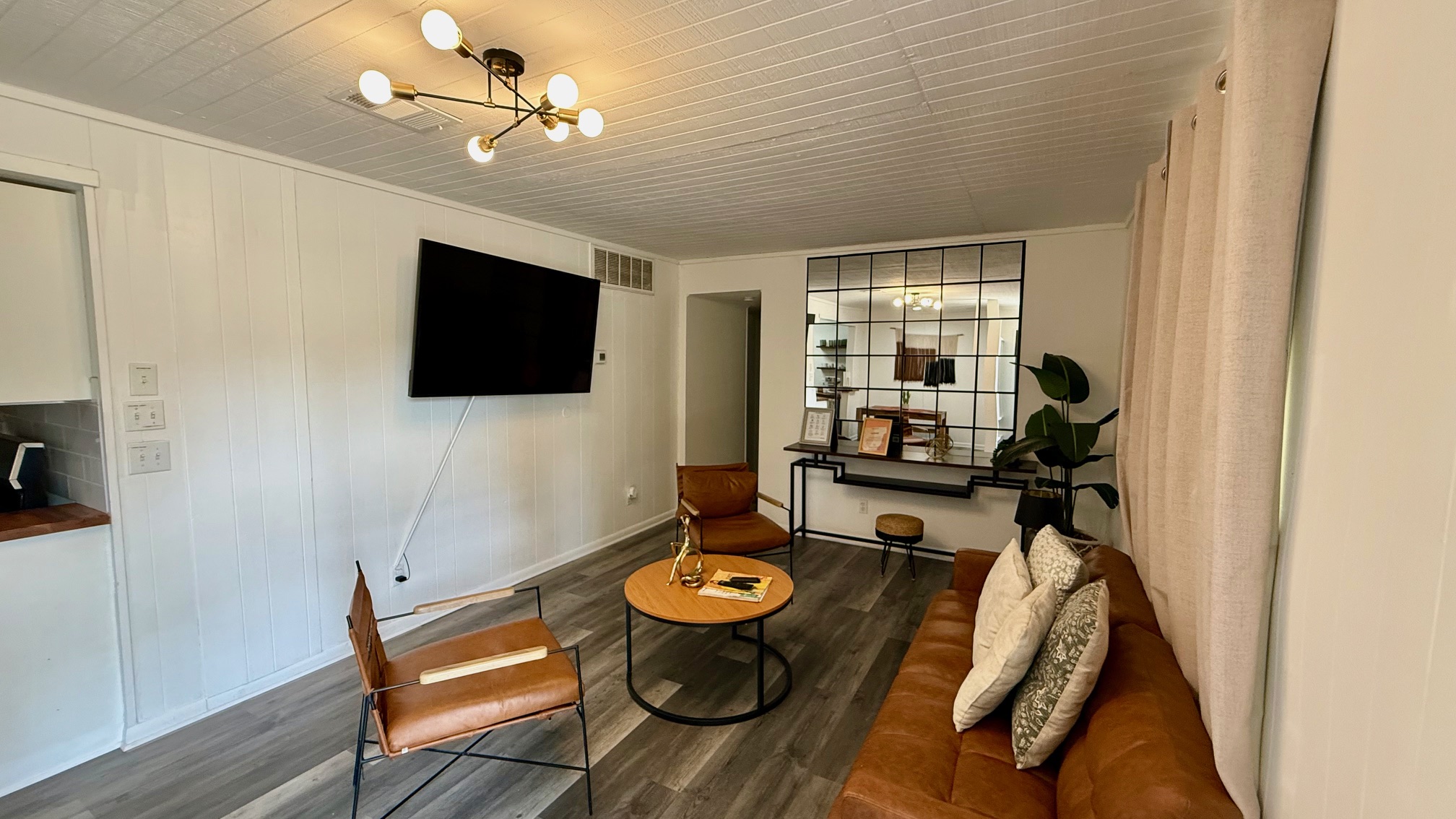 1802 East University Avenue, Unit A Georgetown, TX 78626 - Photo 23 of 23 Living area featuring dark wood-style floors, a chandelier, wood walls, and wooden ceiling