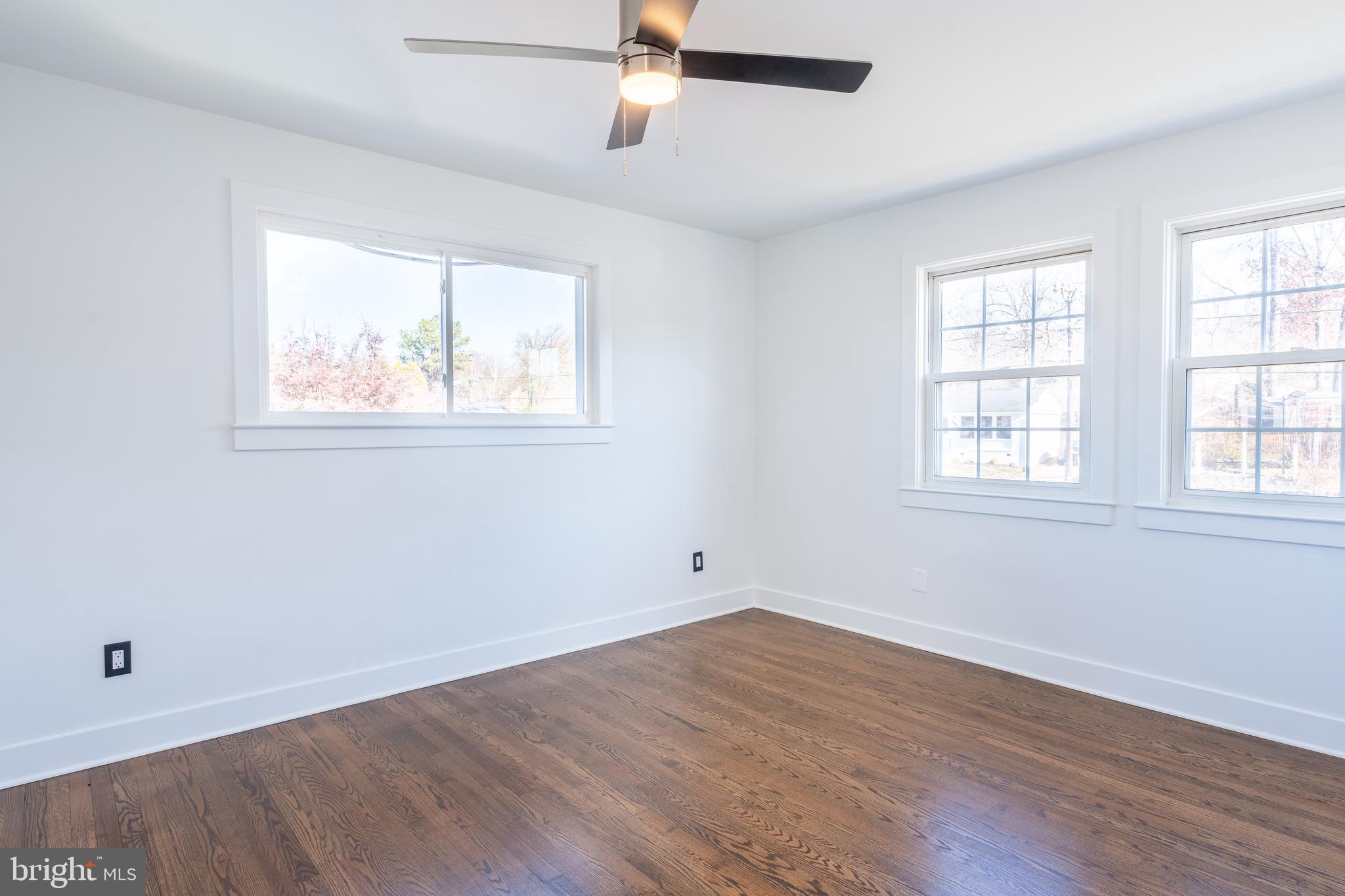 13208 Holdridge Road Silver Spring, MD 20906 - Photo 13 of 29 an empty room with wooden floor and windows