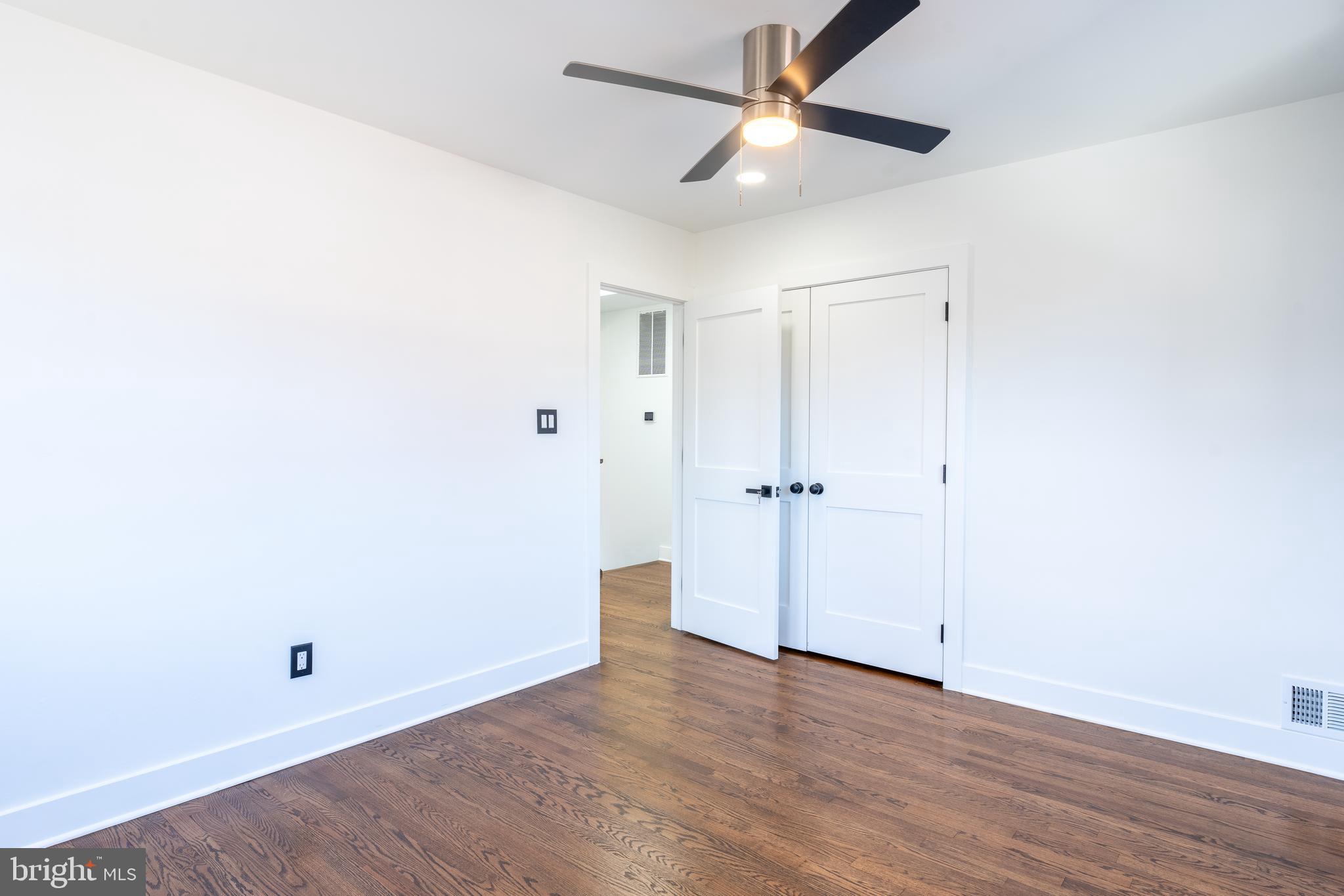 13208 Holdridge Road Silver Spring, MD 20906 - Photo 14 of 29 an empty room with wooden floor and ceiling fan