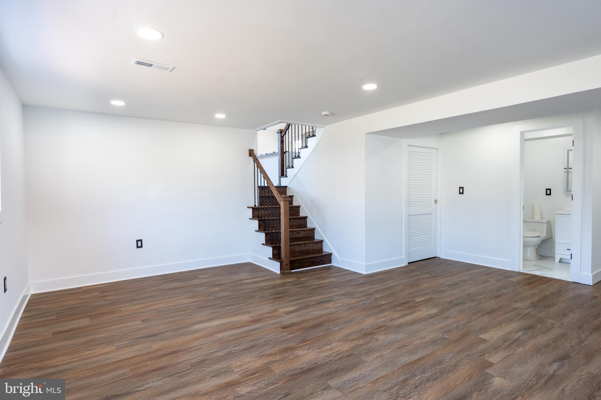 13208 Holdridge Road Silver Spring, MD 20906 - Photo 17 of 29 a view of an empty room with wooden floor and stairs