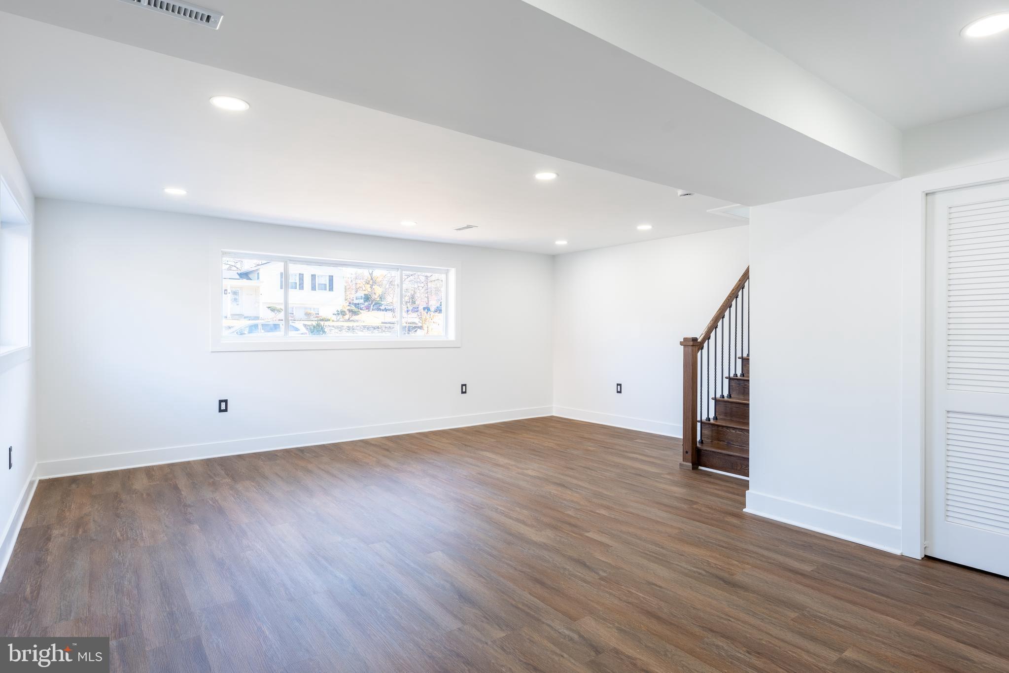 13208 Holdridge Road Silver Spring, MD 20906 - Photo 18 of 29 an empty room with wooden floor and window