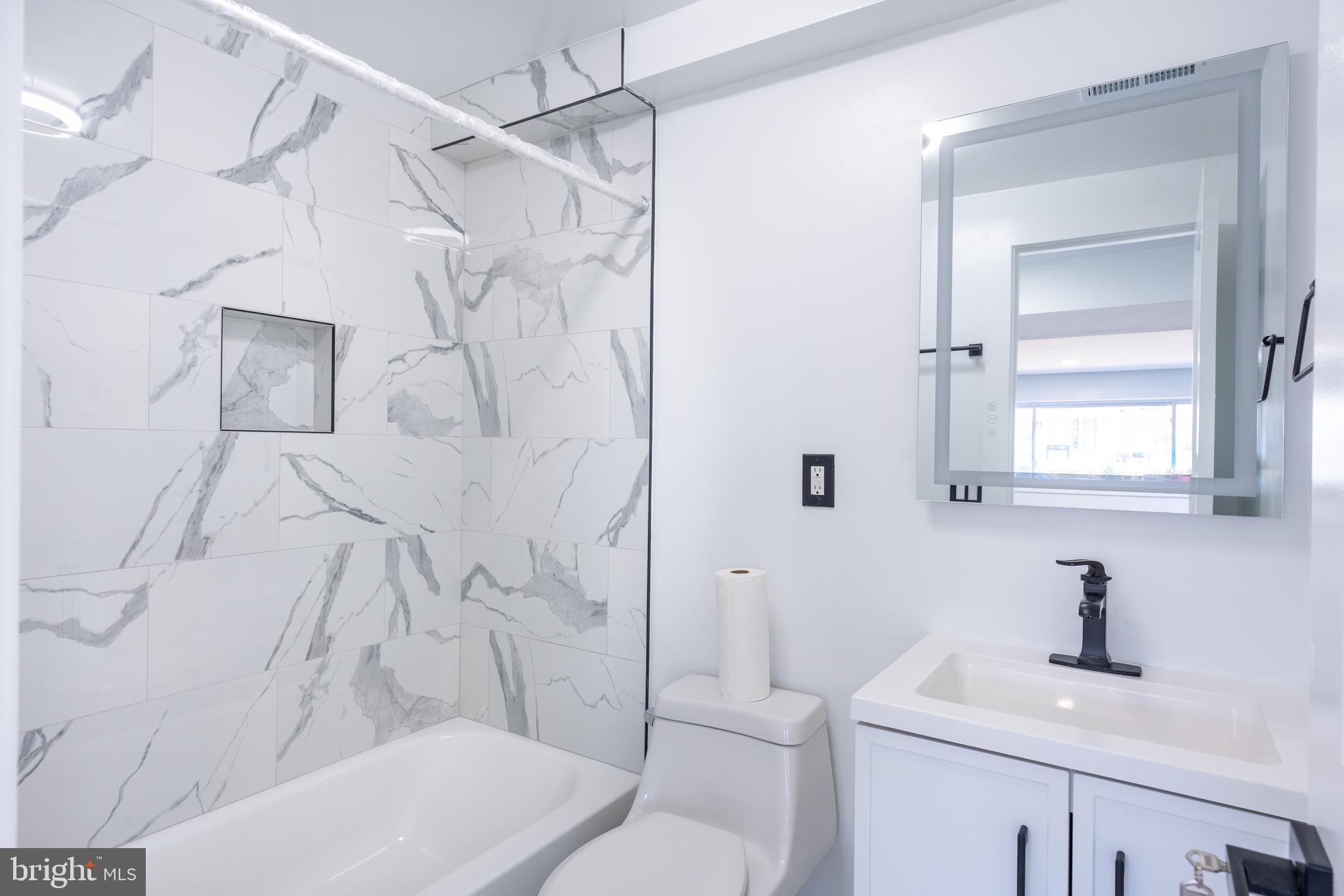13208 Holdridge Road Silver Spring, MD 20906 - Photo 20 of 29 a bathroom with a sink toilet and shower