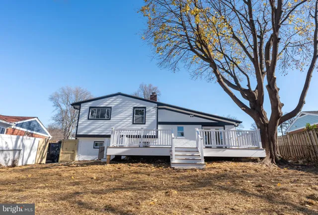 a white house that has a tree in front of it