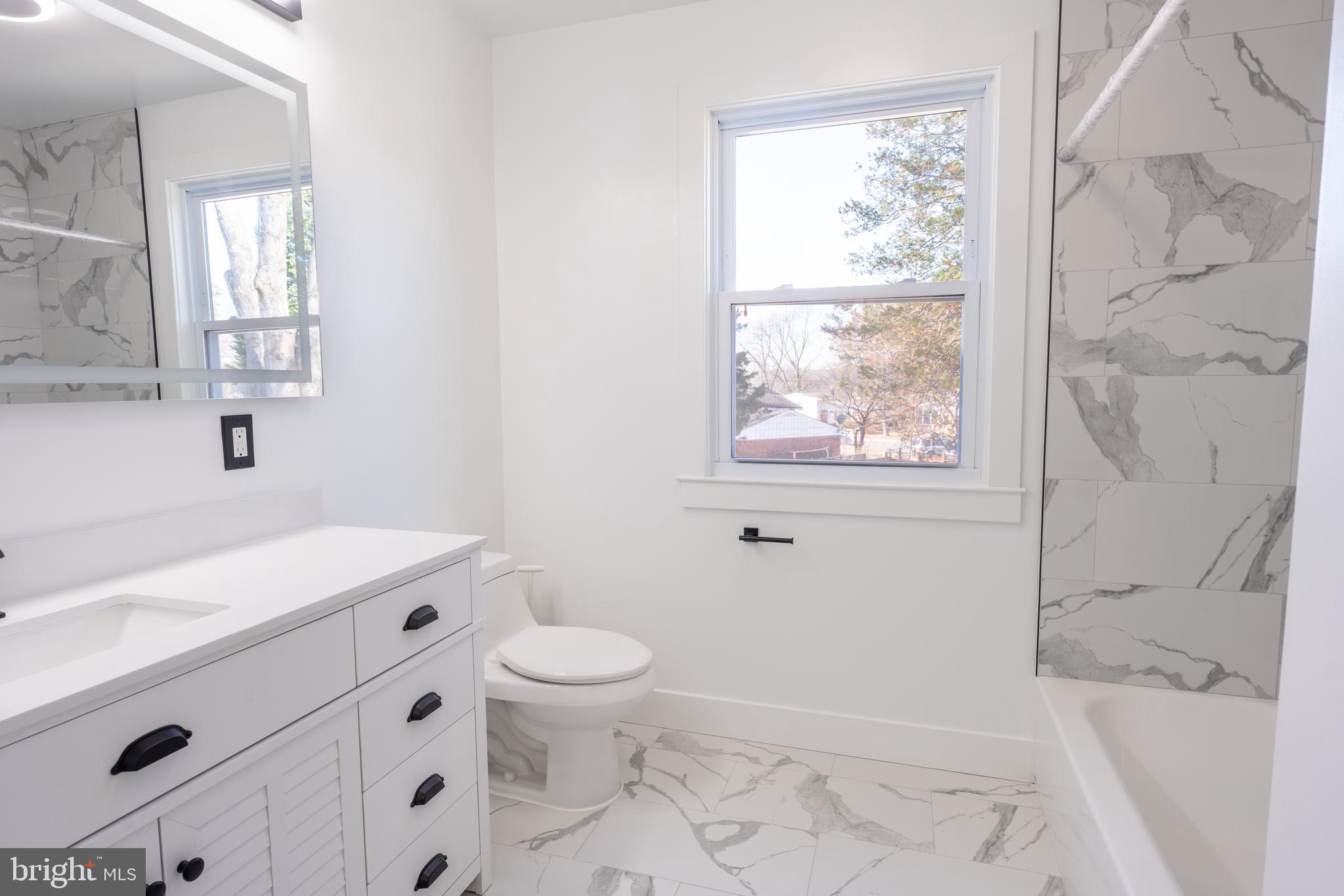 13208 Holdridge Road Silver Spring, MD 20906 - Photo 7 of 29 a bathroom with a sink a toilet and tub