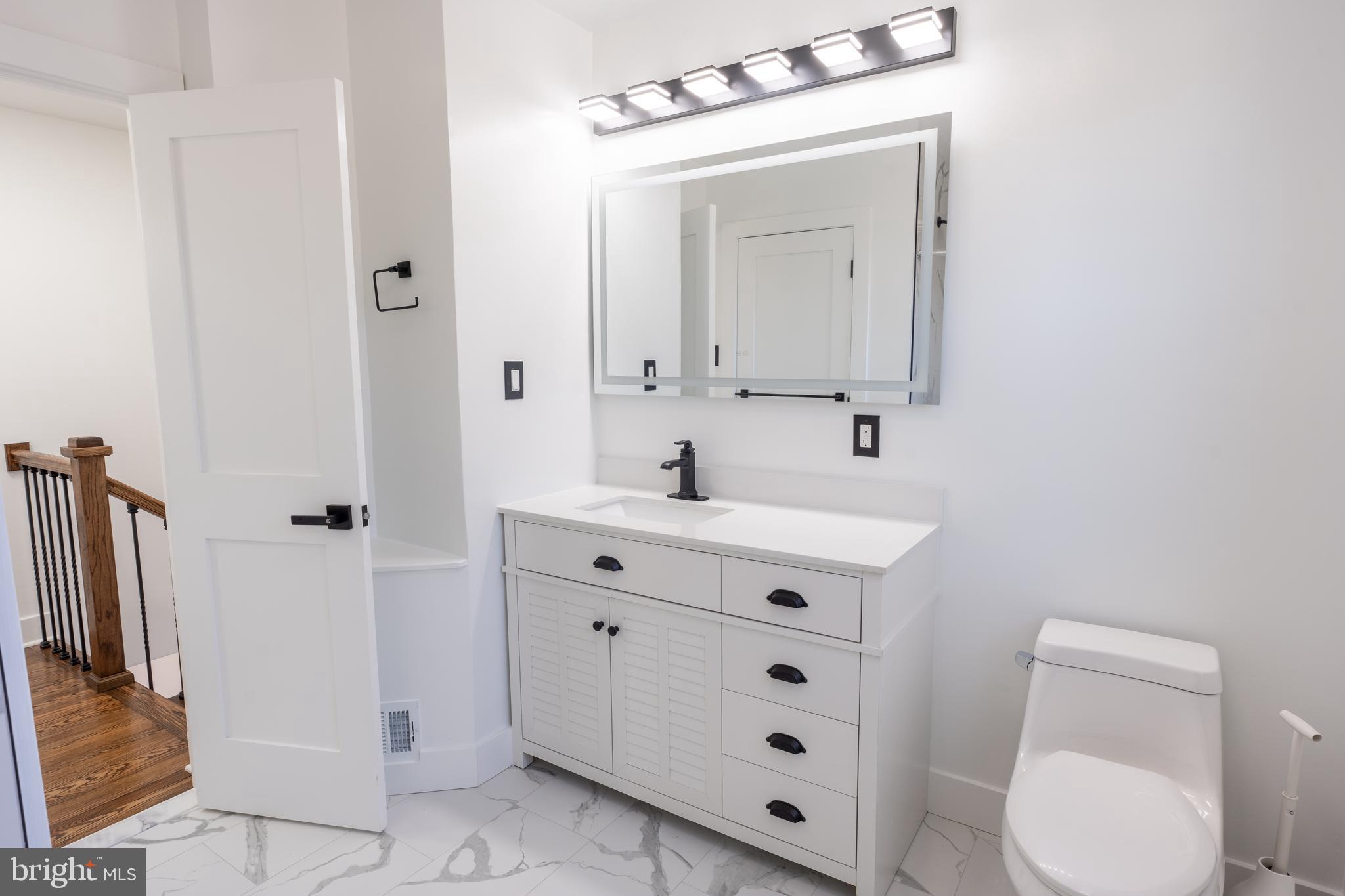 13208 Holdridge Road Silver Spring, MD 20906 - Photo 9 of 29 a bathroom with a toilet sink and mirror