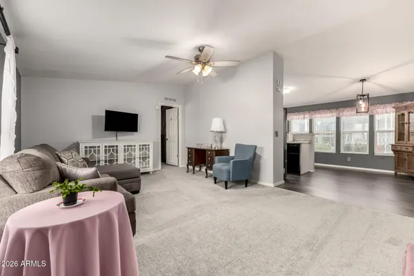 a living room with furniture a fireplace and a chandelier