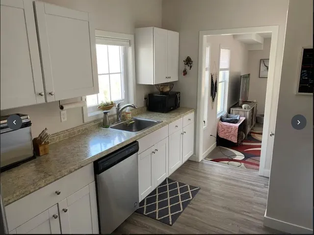 a kitchen with stainless steel appliances a sink stove and cabinets