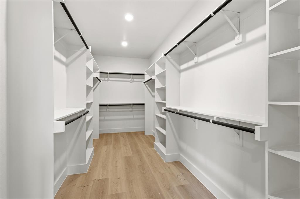 415 North Patton Avenue Dallas, TX 75203 - Photo 12 of 20 The walk-in closet features ample shelving, hanging rods, recessed lighting, and light-toned flooring