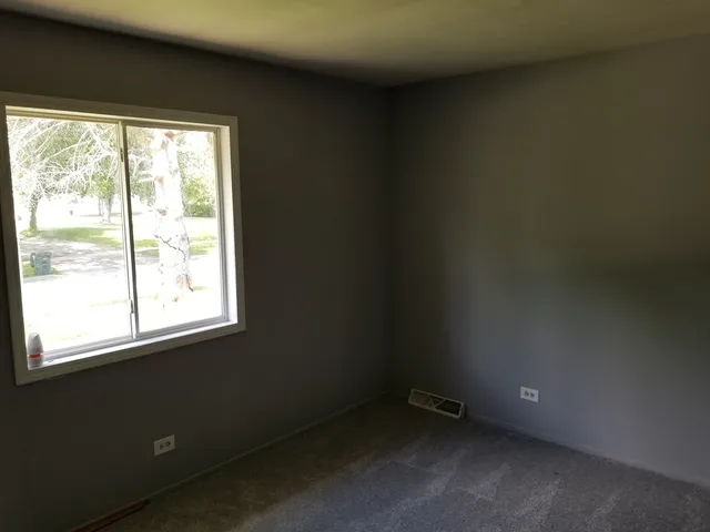 a view of an empty room and a window