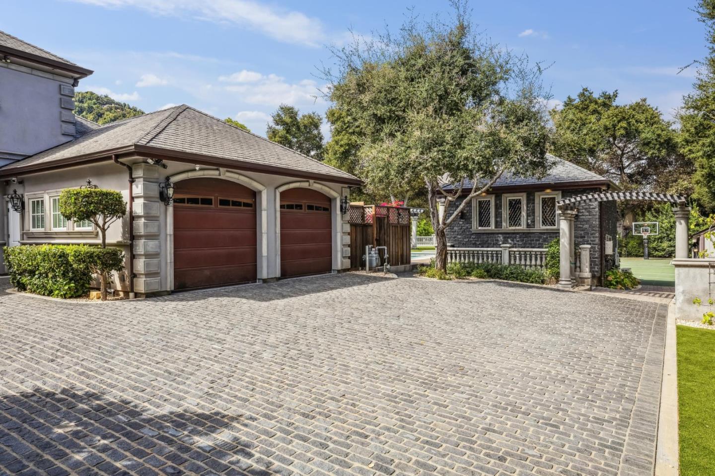 15253 Montalvo Road Saratoga, CA 95070 - Photo 103 of 104 a front view of a house with a yard and garage