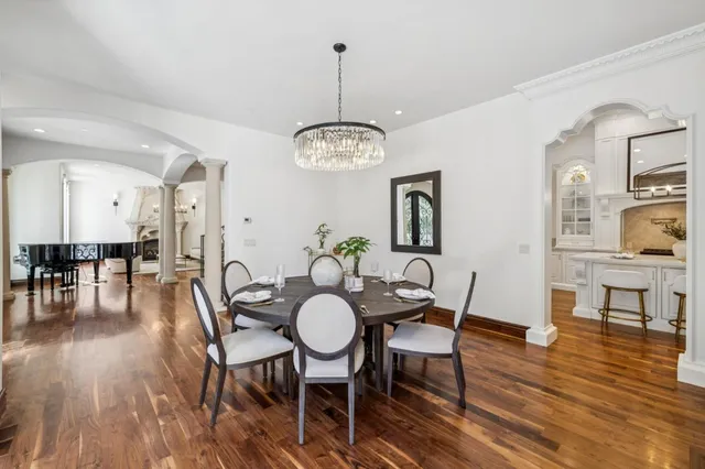a view of a swimming pool with a lounge chair and trees in the background