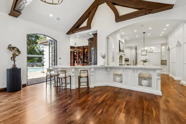 a front view of a house with a yard and potted plants