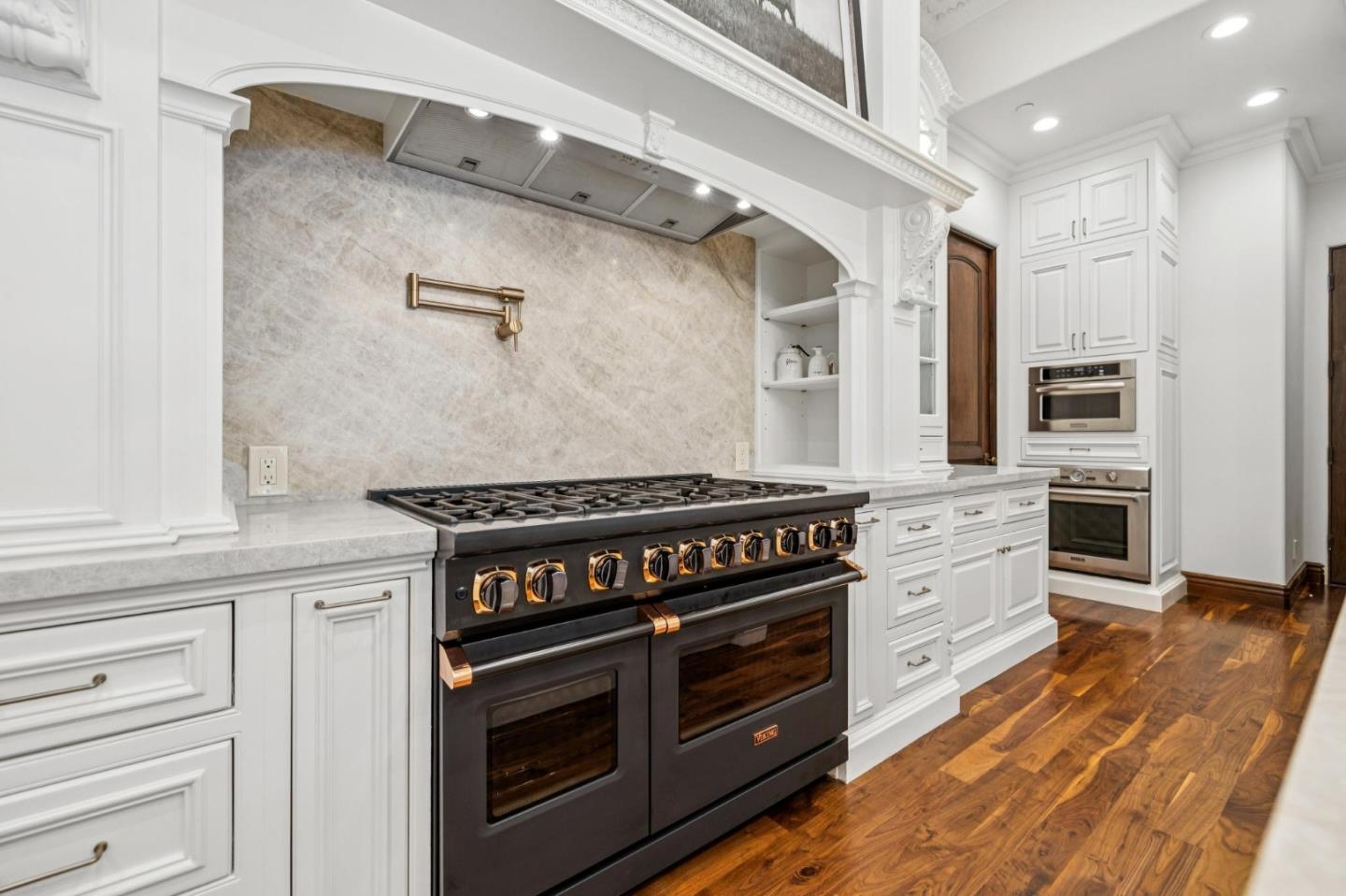 15253 Montalvo Road Saratoga, CA 95070 - Photo 35 of 104 a kitchen with stainless steel appliances granite countertop a stove and a refrigerator