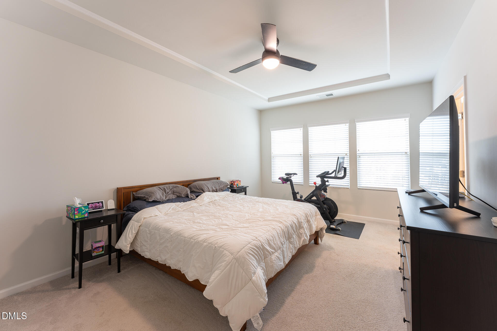 1296 Barn Cat Way Apex, NC 27502 - Photo 11 of 22 a bedroom with a bed and large windows