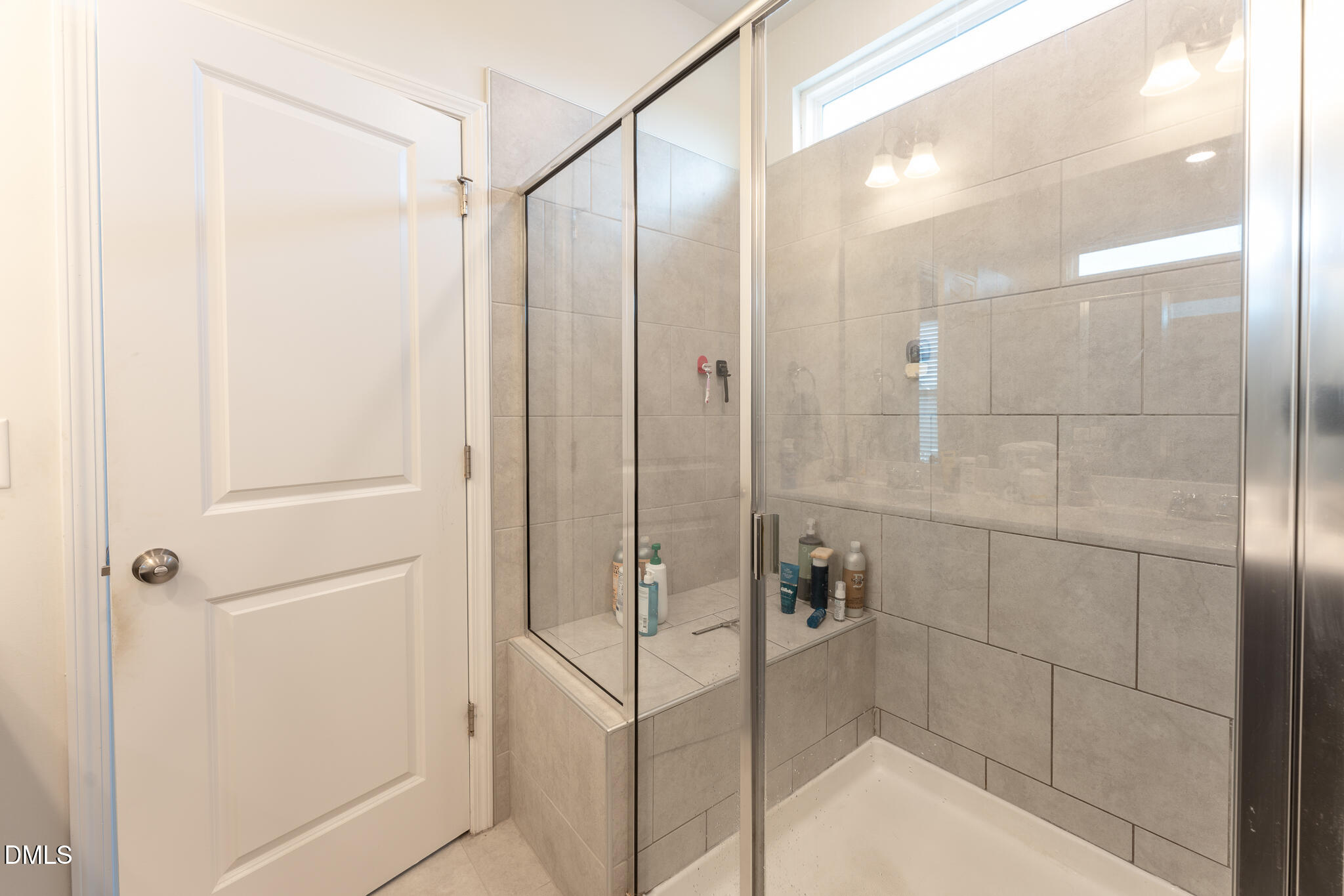 1296 Barn Cat Way Apex, NC 27502 - Photo 13 of 22 a bathroom with a glass shower door