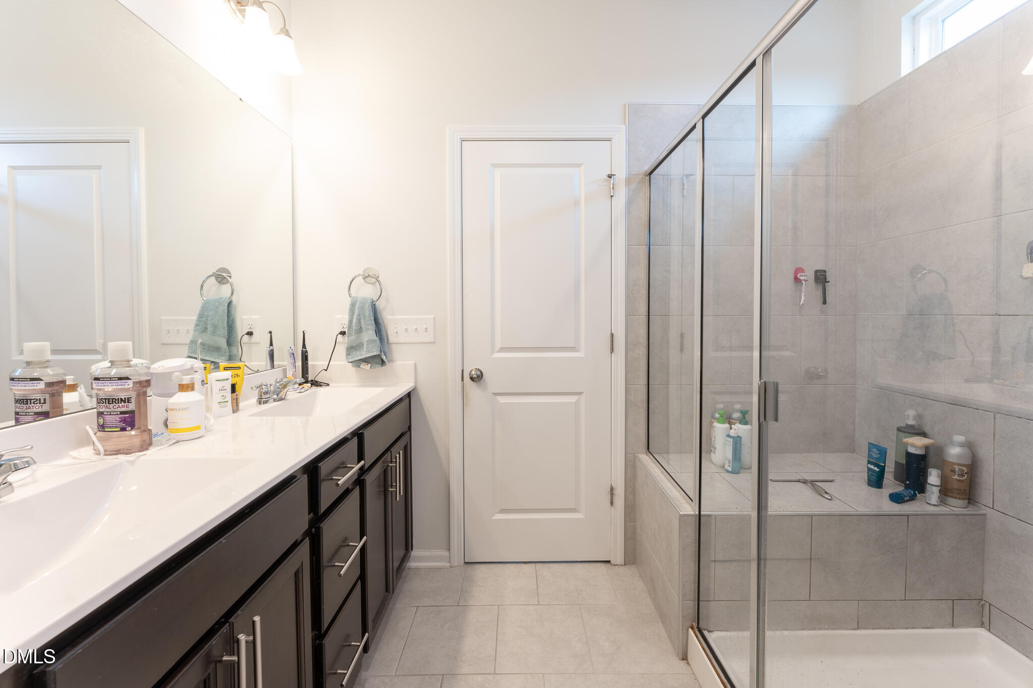 1296 Barn Cat Way Apex, NC 27502 - Photo 14 of 22 a bathroom with a double vanity sink mirror and shower