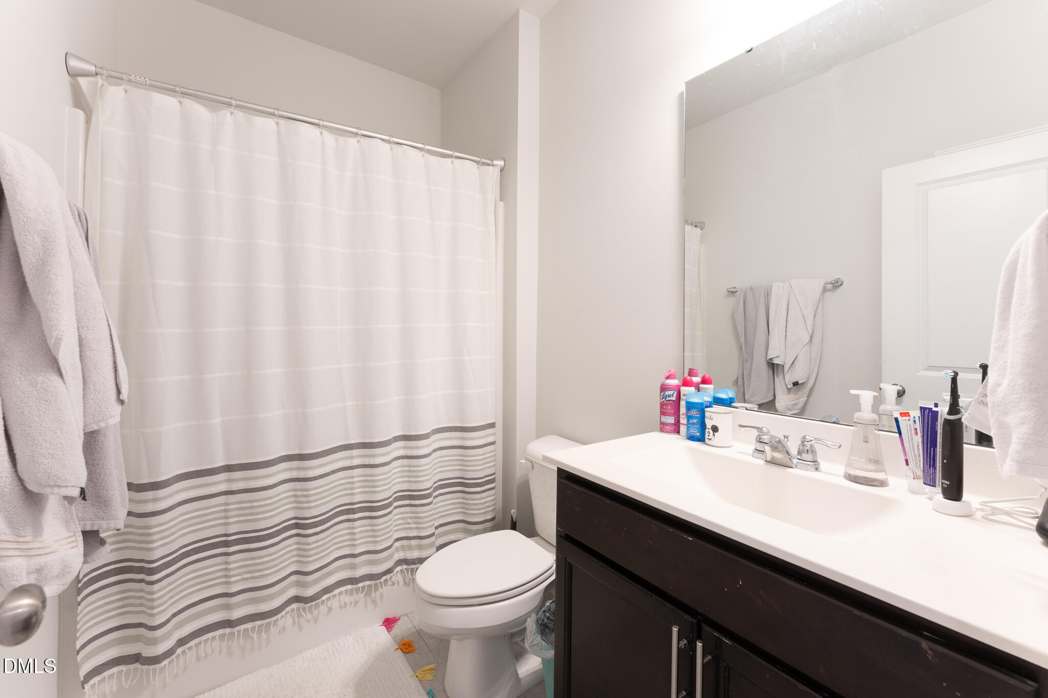 1296 Barn Cat Way Apex, NC 27502 - Photo 16 of 22 a bathroom with a sink a toilet and a mirror