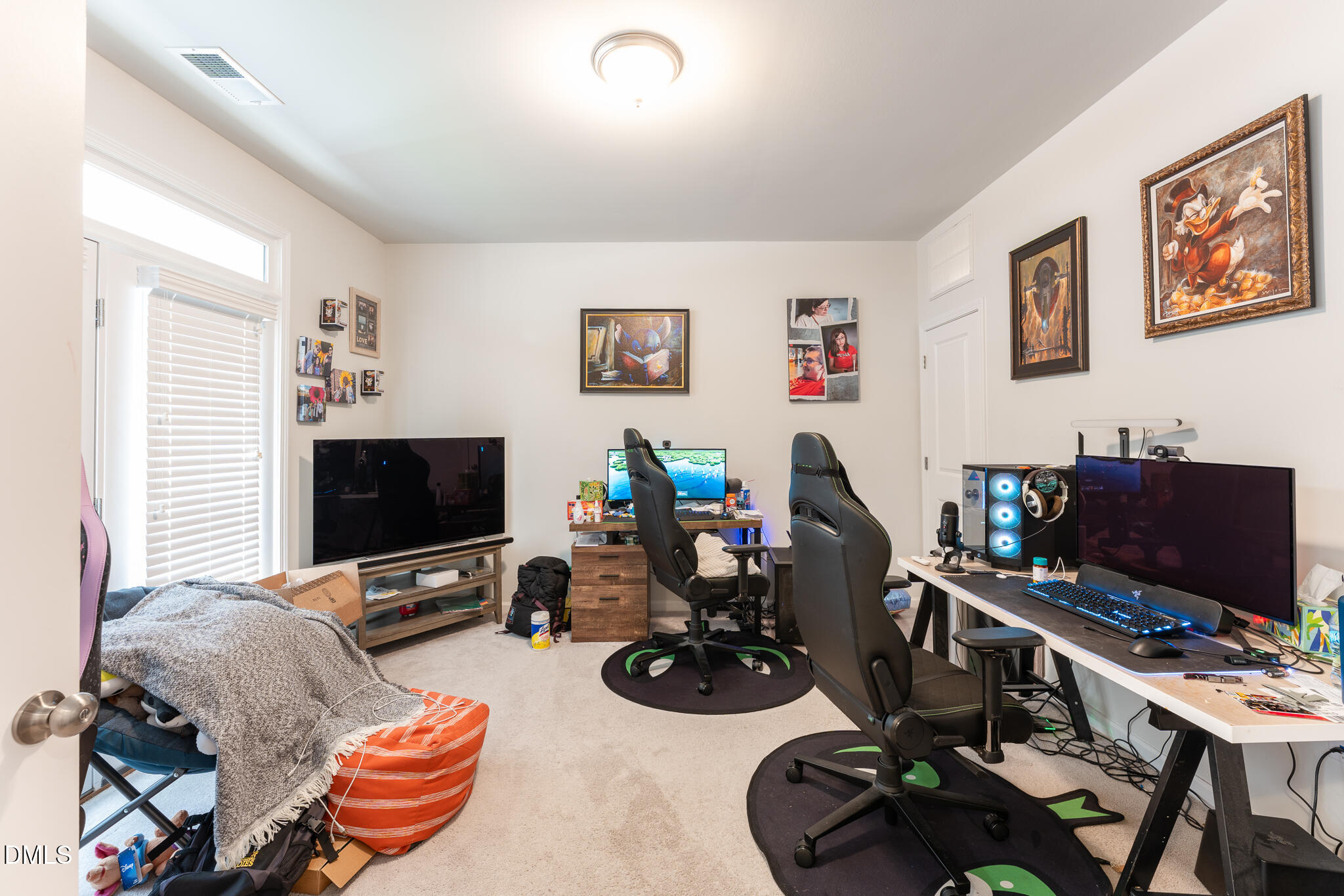 1296 Barn Cat Way Apex, NC 27502 - Photo 20 of 22 a view of a workspace with furniture and a flat screen tv