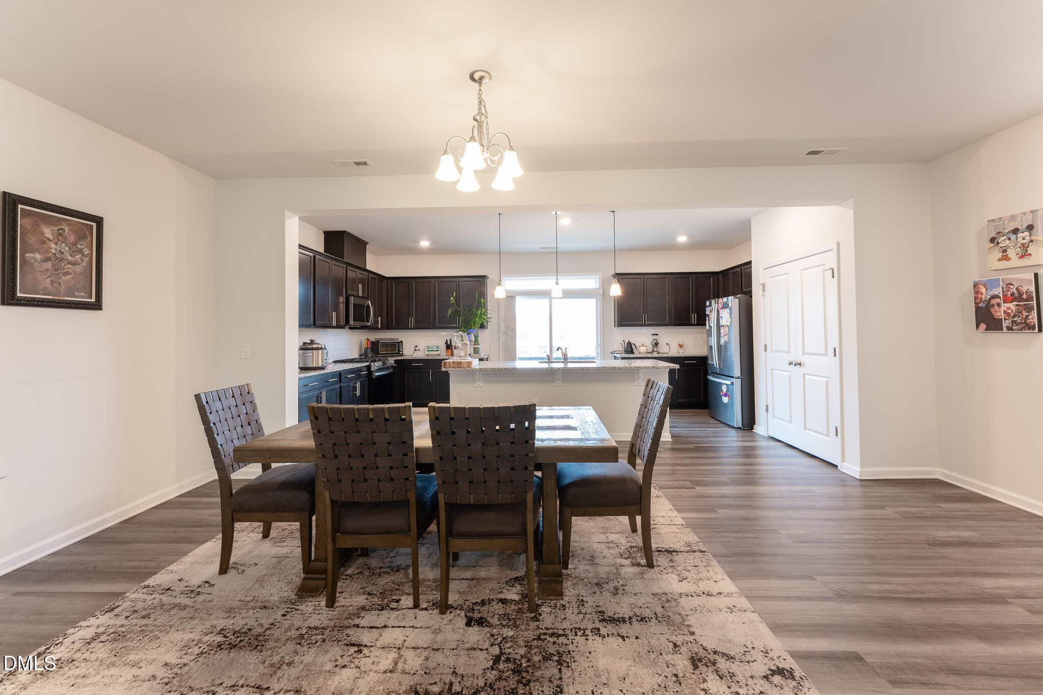 1296 Barn Cat Way Apex, NC 27502 - Photo 7 of 22 a view of a dining room with furniture and wooden floor
