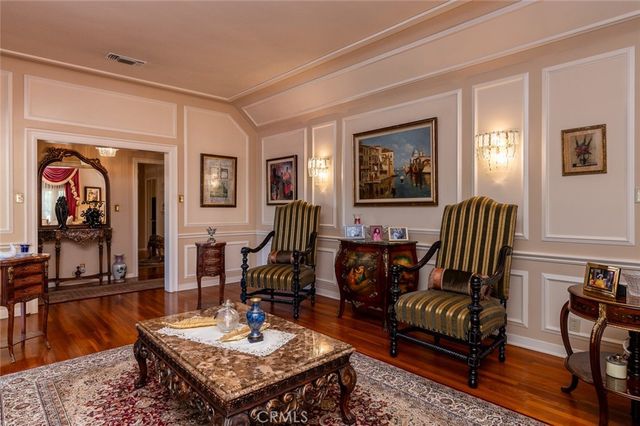 a kitchen with stainless steel appliances granite countertop a stove top oven a dining table and chairs with wooden floor