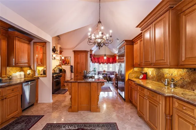 a kitchen with stainless steel appliances a stove a sink and a refrigerator