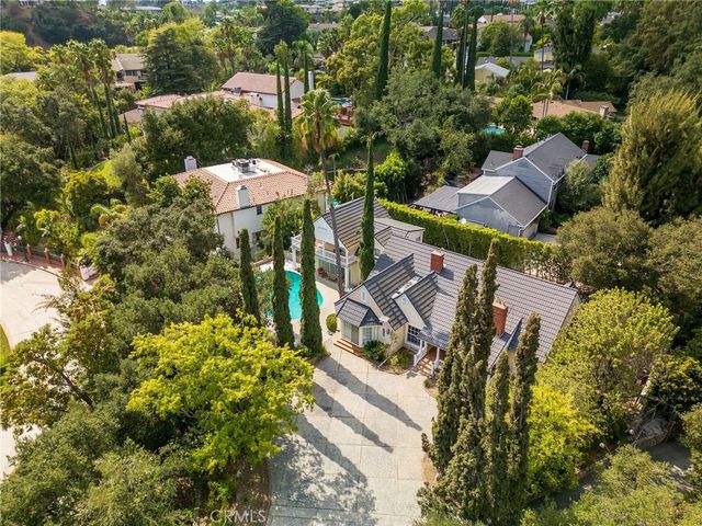 an aerial view of a house with a yard basket ball court and outdoor seating