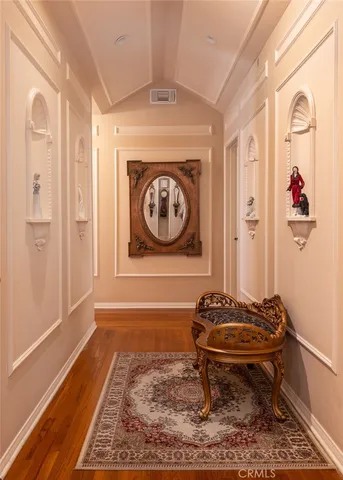 a living room with furniture a wooden floor and a large window