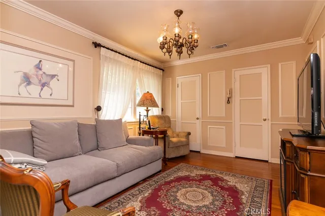 a living room with furniture a flat screen tv and a large window