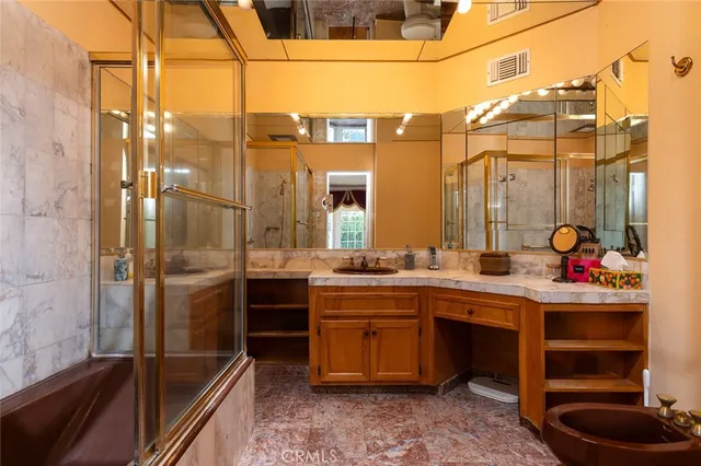 a bedroom with a bed and dresser with mirror