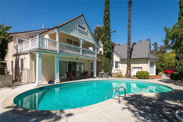 a view of a house with a yard and sitting area