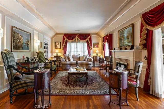a living room with furniture a fireplace and a large window