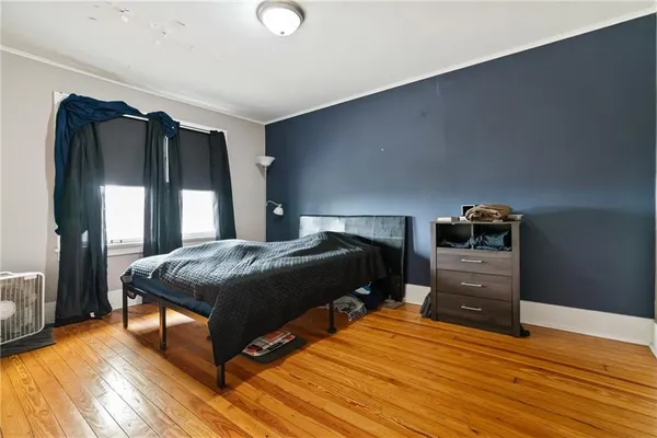 a bedroom with a bed and a dresser