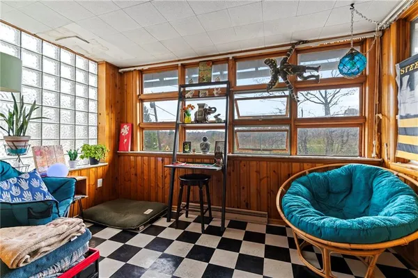 a living room with furniture and a floor to ceiling window