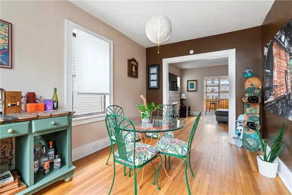 a view of a dining room with furniture and wooden floor