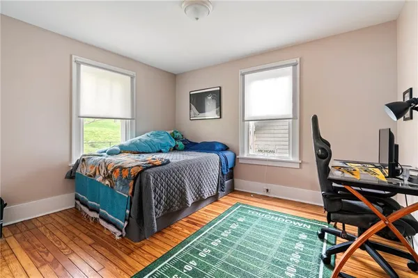 a bed sitting in a bedroom next to a window