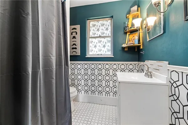 a bathroom with a sink a mirror and a shower