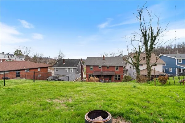 a view of a house with a yard and sitting area