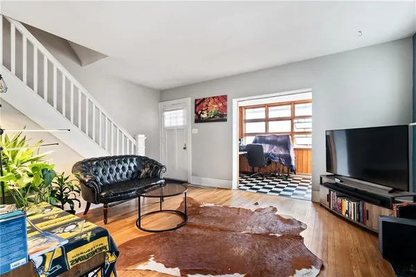 a living room with furniture and a flat screen tv