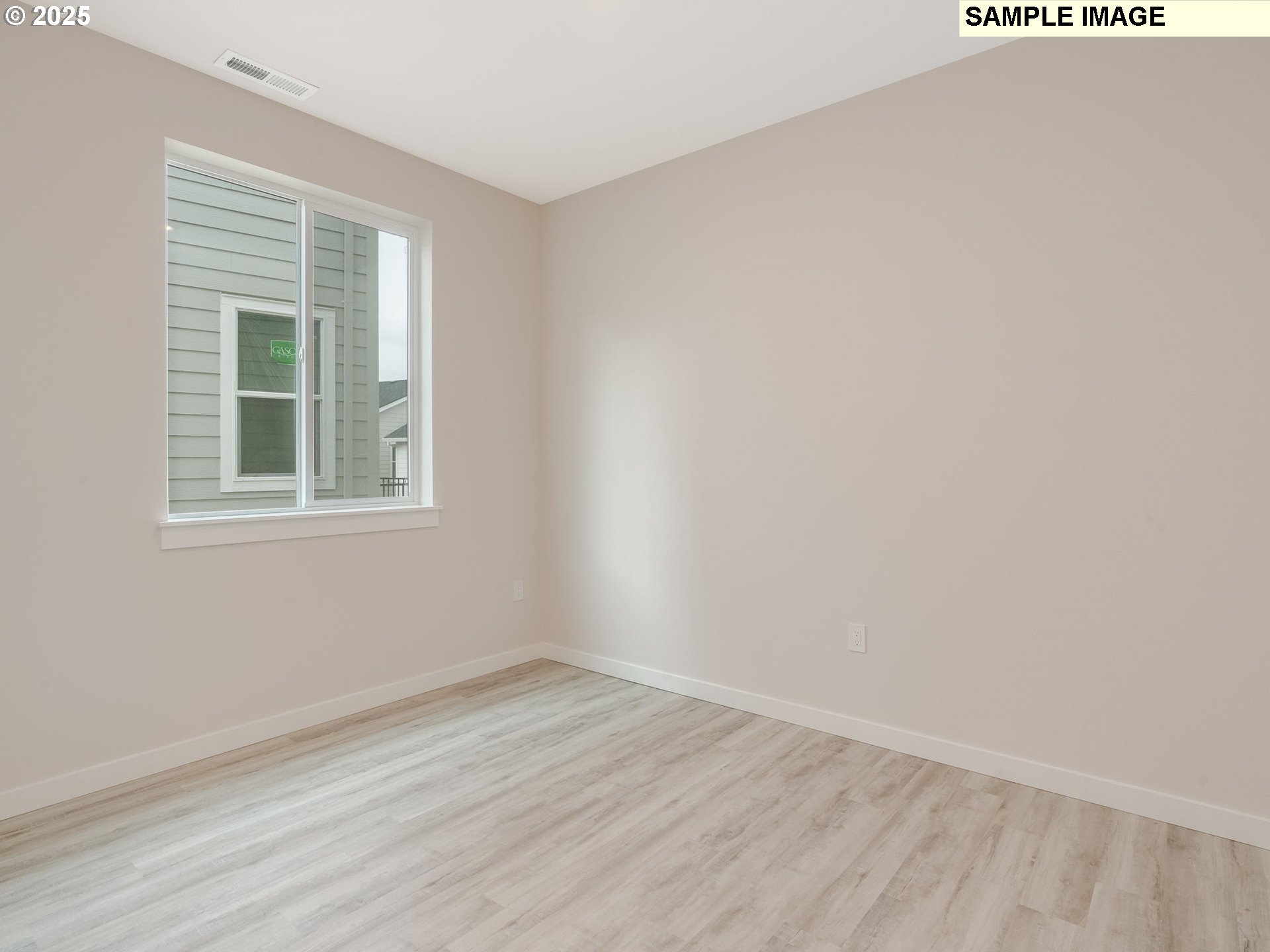 2111 Northeast Ridge Run Lane Estacada, OR 97023 - Photo 5 of 45 an empty room with wooden floor and windows