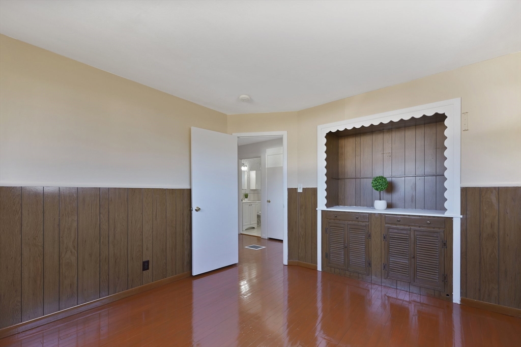 51 Broadleaf Lane Enfield, CT 06082 - Photo 19 of 36 a view of a hallway with wooden floor and a cabinet