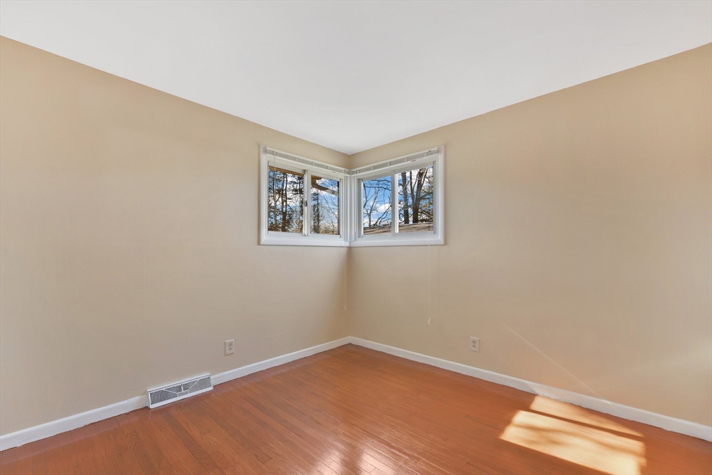 51 Broadleaf Lane Enfield, CT 06082 - Photo 20 of 36 a view of an empty room with wooden floor and a window