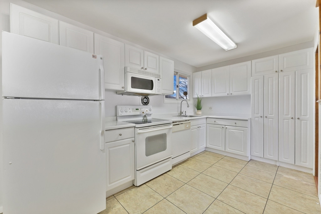 51 Broadleaf Lane Enfield, CT 06082 - Photo 3 of 36 a kitchen with white cabinets and white appliances