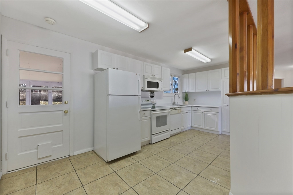 51 Broadleaf Lane Enfield, CT 06082 - Photo 4 of 36 a kitchen with white cabinets and white appliances