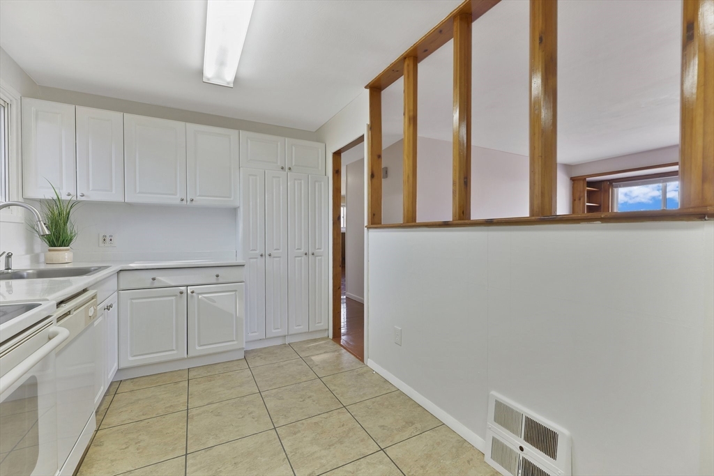 51 Broadleaf Lane Enfield, CT 06082 - Photo 6 of 36 a kitchen with a refrigerator a stove top oven and cabinets