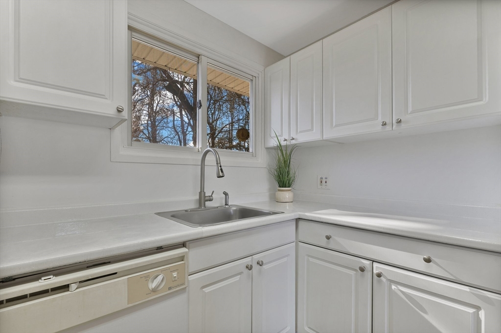 51 Broadleaf Lane Enfield, CT 06082 - Photo 7 of 36 a kitchen with a sink and cabinets
