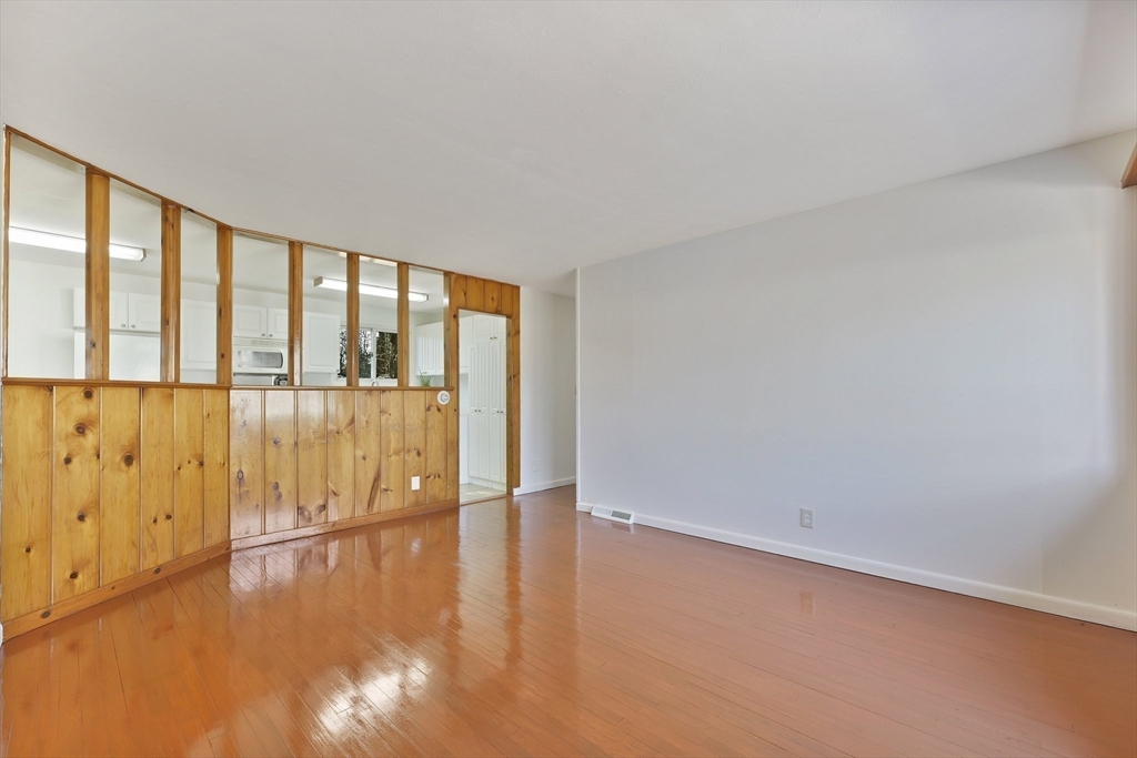 51 Broadleaf Lane Enfield, CT 06082 - Photo 9 of 36 a view of an empty room with wooden floor and a window