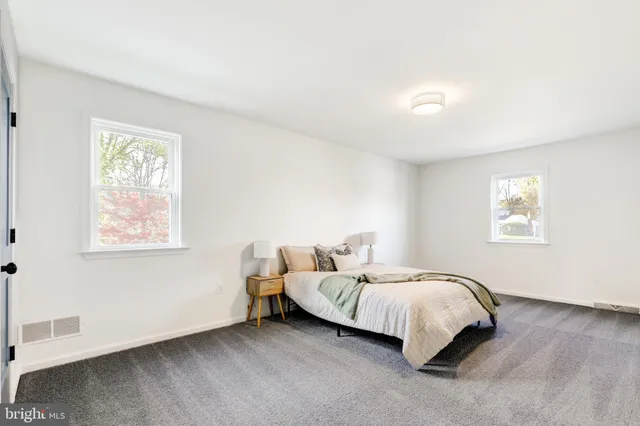 a bed room with a bed and a window