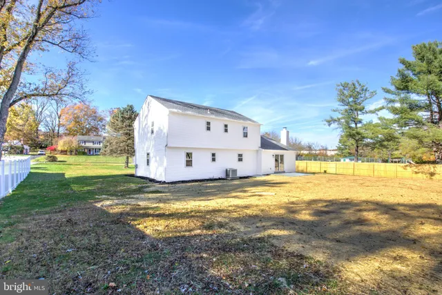 a view of a house with a yard and tree