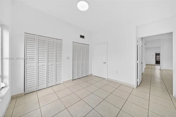 a large white kitchen with white cabinets